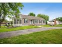 Ranch-style home with neutral siding, well-maintained lawn, and a classic wishing well on the property at 9841 E Raymond St, Indianapolis, IN 46239