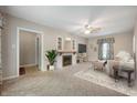 Inviting living room features a fireplace, ceiling fan, and a cozy atmosphere for relaxation and entertainment at 9841 E Raymond St, Indianapolis, IN 46239