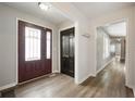Inviting entryway featuring a stained-glass door, coat hooks, and durable wood-look flooring at 1011 Yellow Brick Rd, Pendleton, IN 46064