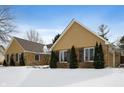 A charming view of a stone house featuring gable roofs, windows with shutters and evergreen bushes at 1011 Yellow Brick Rd, Pendleton, IN 46064