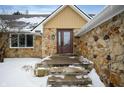 Inviting front entrance featuring a stone facade and a classic front door with glass inserts at 1011 Yellow Brick Rd, Pendleton, IN 46064