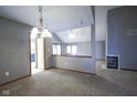 Spacious living room with high ceilings, carpet floors, and a cozy fireplace at 10953 Mount Vernon N Trl, Indianapolis, IN 46229