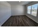 Bright room featuring hardwood floors, white walls, and a large window at 11322 N Quillow Way, Monrovia, IN 46157