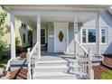 Inviting front porch features classic railings, decorative flowers, and a clear view of the entrance door at 1339 S East St, Indianapolis, IN 46225