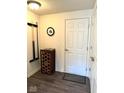 Inviting entryway with dark floors, a wine rack, and convenient coat hooks at 16046 Coleman Dr, Westfield, IN 46074