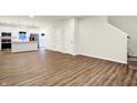 Bright, open-concept living area with modern finishes, wood flooring, and adjacent kitchen at 19517 Grassy Branch Rd, Westfield, IN 46074