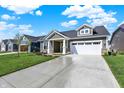 Attractive single-story home with a concrete driveway and landscaped front yard at 19726 Highclere Ln, Sheridan, IN 46069