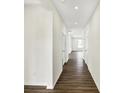 Long hallway featuring clean white walls and modern wood-look flooring at 19726 Highclere Ln, Sheridan, IN 46069