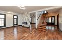 Spacious living room featuring wood floors, black trim, an accent fireplace, and ample natural light at 2828 N Illinois St, Indianapolis, IN 46208