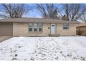 Charming one-story home featuring a stone facade, attached garage, and well manicured lawn at 313 Lawndale Dr, Plainfield, IN 46168