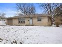 Charming one-story home featuring a stone facade, attached garage, and well manicured lawn at 313 Lawndale Dr, Plainfield, IN 46168