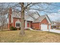 Attractive two-story home with brick and gray siding, complemented by a well-manicured lawn at 3226 Raylin Dr, Indianapolis, IN 46227