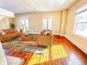 Bright living room with beautiful hardwood floors, ample natural light, and a cozy seating area at 3236 Central Ave, Indianapolis, IN 46205