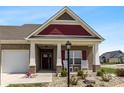 Inviting front porch with classic columns, a dark entryway door and seating area at 3629 S Meadows Ln, New Palestine, IN 46163