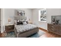 Cozy bedroom featuring a window, a queen bed, two nightstands, and a dresser at 3843 Gray Pond Ct, Indianapolis, IN 46237