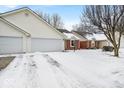 Home featuring an attached two-car garage with a long driveway at 3843 Gray Pond Ct, Indianapolis, IN 46237