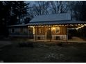 Charming home featuring a covered front porch adorned with string lights creating a warm, inviting ambiance at 4516 Ridge Rd, Anderson, IN 46013