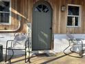 Inviting front porch with rocking chairs and a 'Welcome' sign, creating a cozy and welcoming atmosphere at 4516 Ridge Rd, Anderson, IN 46013
