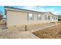 Well-maintained single story home with light siding and well-manicured gravel landscaping at 480 Tague St, Greenfield, IN 46140