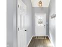 Inviting entryway with light gray walls, wood floors, and a coat rack for added convenience at 4925 Royal Orbit Ct, Indianapolis, IN 46237