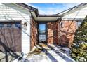 Welcoming front entrance with a brick surround, a storm door, and exterior lighting fixtures at 4925 Royal Orbit Ct, Indianapolis, IN 46237