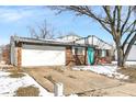 Charming brick home features an attached garage, and a pop of color with the bright blue front door at 5614 Personality Ct, Indianapolis, IN 46237