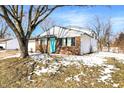 Charming brick home features an attached garage, and a pop of color with the bright blue front door at 5614 Personality Ct, Indianapolis, IN 46237