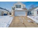 Charming two-story home with a two-car garage and a long driveway at 5638 Congressional Pl, Indianapolis, IN 46235