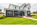 Beautiful two-story model home with a green lawn, brick and white siding, and pretty flowerbeds at 5879 Handbell Ln, Greenwood, IN 46143