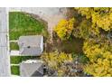 Birds-eye view of the property showing the house, yard, and surrounding trees in fall colors at 638 W 30Th St, Indianapolis, IN 46208
