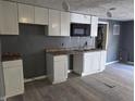A kitchen featuring white cabinets and a microwave installed over the sink area at 724 E Beecher St, Indianapolis, IN 46203