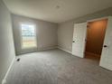 Comfortable bedroom with soft carpeting, ample natural light, and a closet for storage at 7367 Broadview Ln, McCordsville, IN 46055