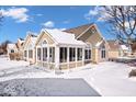 Charming home featuring neutral siding, stone accents, snow-covered lawn, and picturesque blue sky at 7415 Chapel Villas Dr # D, Indianapolis, IN 46214