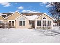 Charming home featuring neutral siding, stone accents, snow-covered lawn, and picturesque blue sky at 7415 Chapel Villas Dr # D, Indianapolis, IN 46214