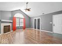 Bright living room features vaulted ceiling, fireplace, rich hardwood flooring, and natural light at 7415 Chapel Villas Dr # D, Indianapolis, IN 46214