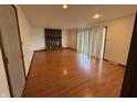 Spacious living room with fireplace and wood flooring, offering ample space for relaxation and entertainment at 806 Country Ln, Anderson, IN 46013