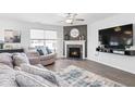 Comfortable living room featuring fireplace, ceiling fan, and plush seating at 8187 Dewberry Ln, Pendleton, IN 46064