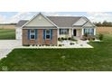 Well-maintained home featuring charming brickwork, blue shutters, and a lush green lawn at 8225 W 825 N, Thorntown, IN 46071