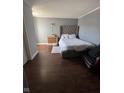Comfortable bedroom features hardwood floors, a upholstered headboard, and a cozy armchair at 1013 Redwood Dr, Lebanon, IN 46052