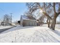 Home exterior in winter with snow-covered yard, highlighting its architecture and neighborhood setting at 1390 Greenfield Ave, Noblesville, IN 46060