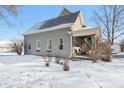 Charming home in winter with snow-covered yard and gray siding, showcasing its curb appeal and seasonal beauty at 1390 Greenfield Ave, Noblesville, IN 46060