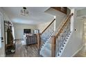 Open living room with hardwood floors, a cozy sofa, and a staircase leading to the upper level at 1403 Backwater Dr, Danville, IN 46122