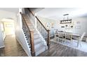 Elegant staircase with wrought iron balusters connects the different floors of this stylish home at 1403 Backwater Dr, Danville, IN 46122