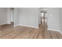 Bright hallway showcasing luxury vinyl plank flooring and neutral paint at 14390 Bishop Birch Pl, Carmel, IN 46032