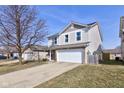 Charming two-story home with a spacious driveway and a well-maintained lawn on a sunny day at 15486 Dusty Trl, Noblesville, IN 46060