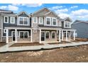 Beautiful townhomes showcase covered entryways, stone veneer, and contemporary exterior at 19487 Grassy Branch Rd, Westfield, IN 46074