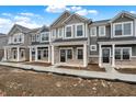 Attractive townhomes feature covered porches, stone accents, and modern exterior finishes at 19487 Grassy Branch Rd, Westfield, IN 46074