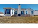 Backyard patio features a low brick retaining wall and a well-maintained lawn at 2228 Silver Rose Dr, Avon, IN 46123