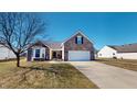 Charming brick home features a two-car garage, bay window, and well-maintained front yard at 2228 Silver Rose Dr, Avon, IN 46123