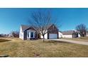 Charming brick home features a two-car garage, bay window, and well-maintained front yard at 2228 Silver Rose Dr, Avon, IN 46123